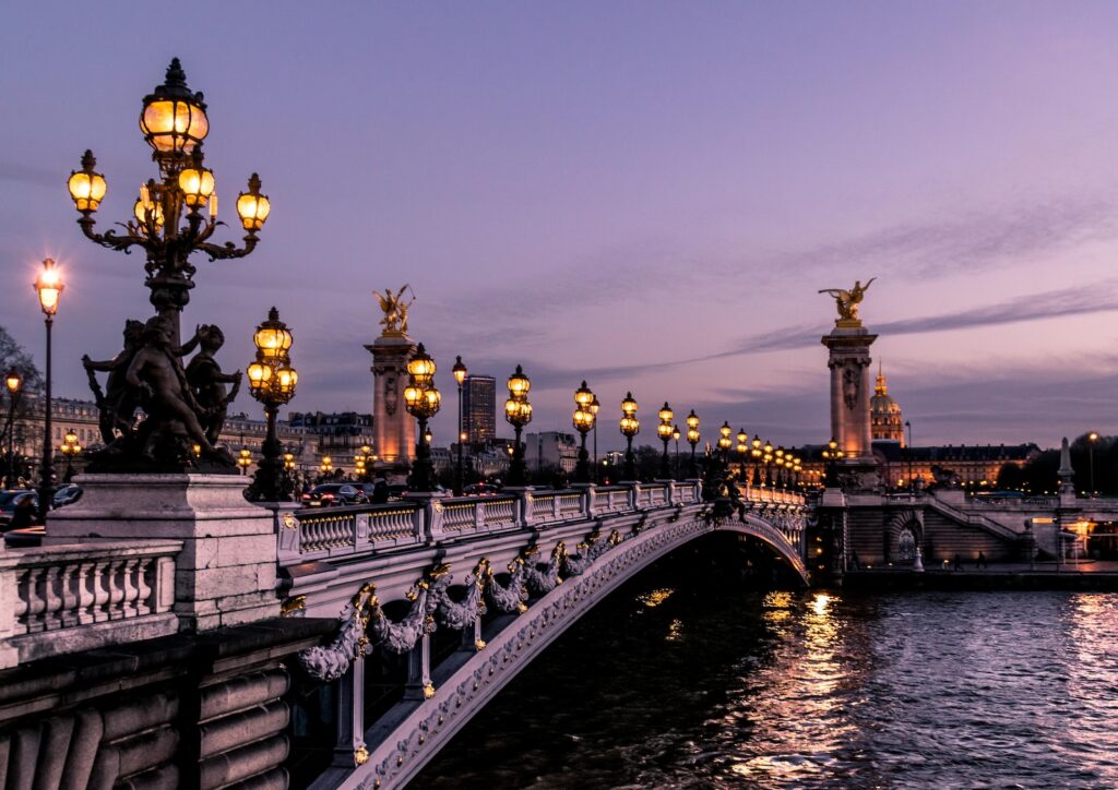 bridge during night time - paris